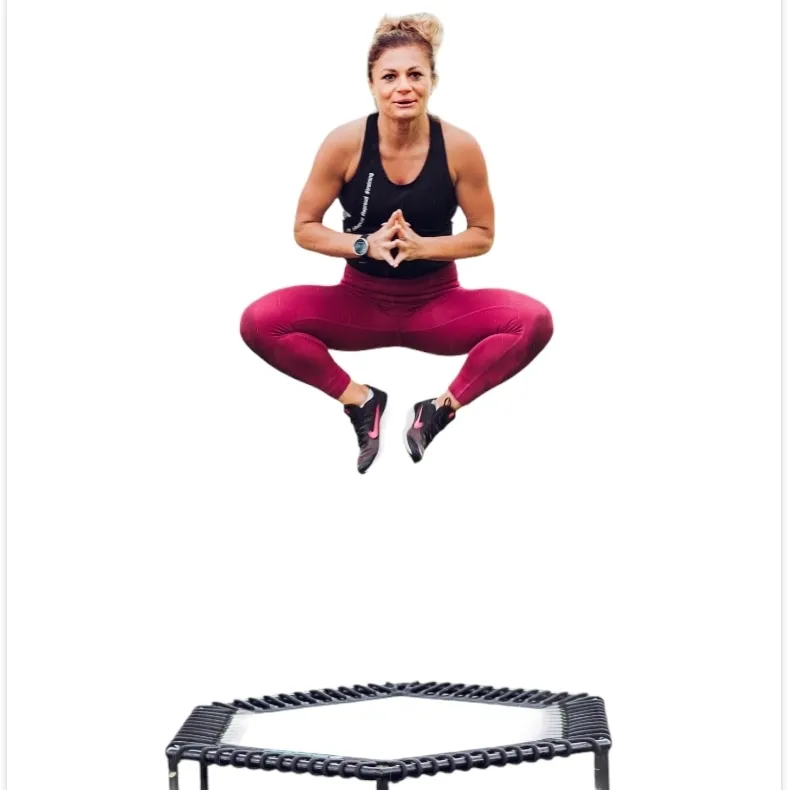 Anna mid-air above a mini trampoline, knees out, hands together