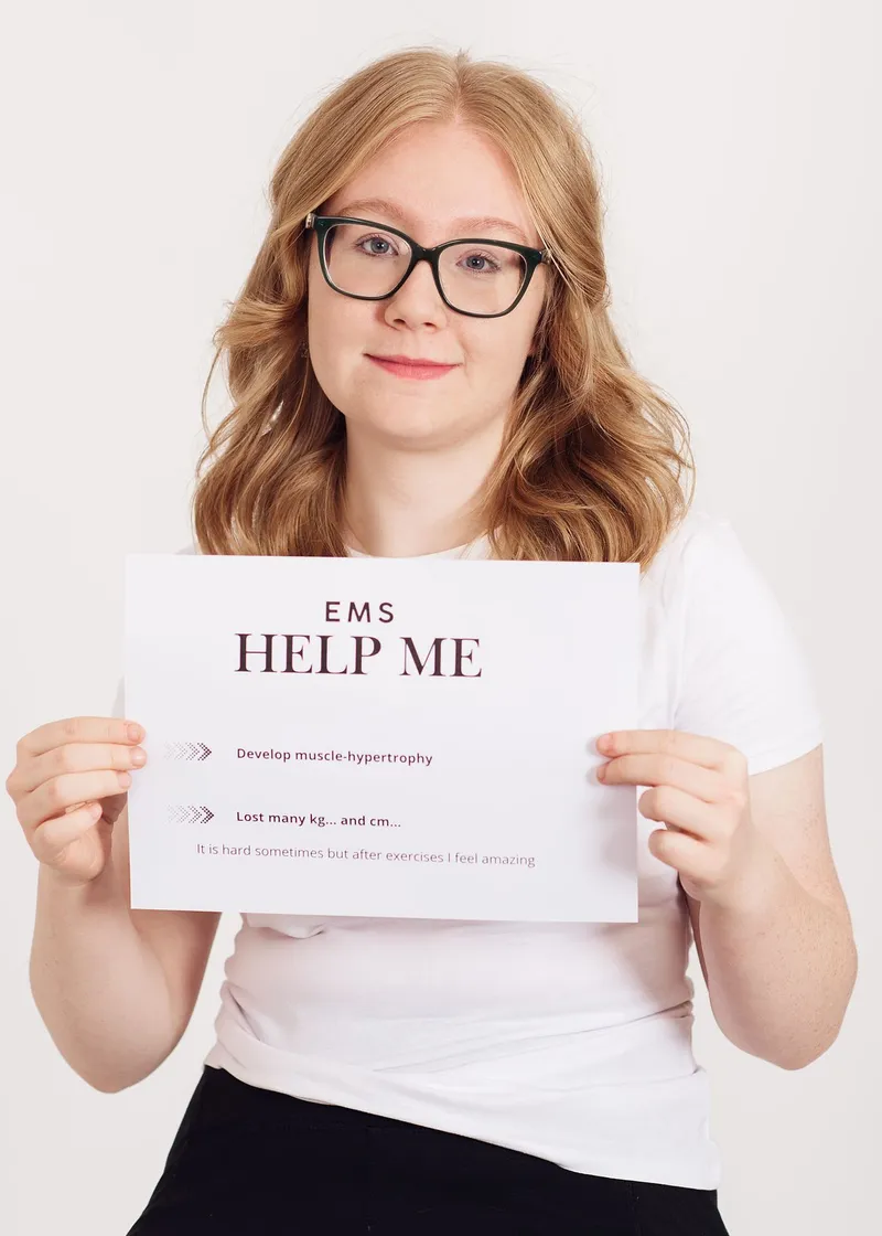 A client in glasses holds a card headed EMS Help Me
